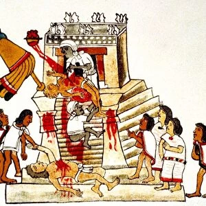 Priest offering the heart taken from a living human victim to the Aztec sun god and god of war