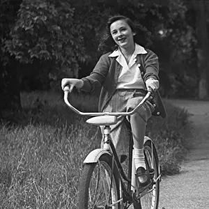 Girl bicycling on path