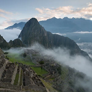 Machu Picchu at Sunrise with rolling fog and clouds