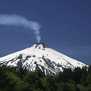 Volcanic smoke rising from Villarrica or Rucapillan Volcano, seen from Pucon, Chile