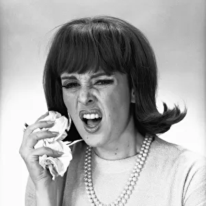 Woman sneezing in studio, (B&W)