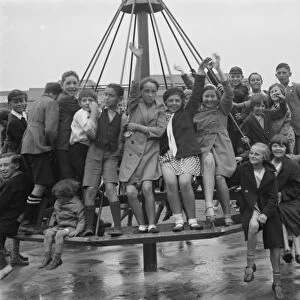 Crayford playground is opened. Children swing on the maypole swing