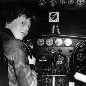 Amelia Earhart at the controls of her plane