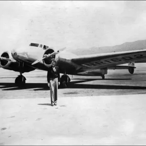 Print of Amelia Earhart standing in front of her plane