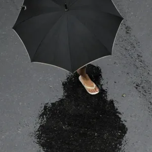 Argentina Weather Print: A Woman Under Heavy Rain in Buenos Aires Argentina Weather Print: A Woman Under Heavy Rain in Buenos Aires