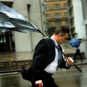 Print of a man battling strong winds and rain in Sydney Print of a man battling strong winds and rain in Sydney