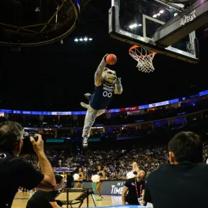 Print of a mascot slam dunking during an NBA game Print of a mascot slam dunking during an NBA game