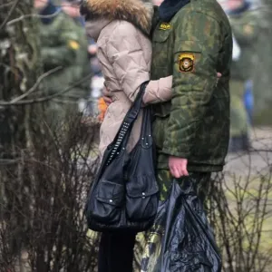 A Belarus soldier shares a tender moment with his sweetheart during their meeting