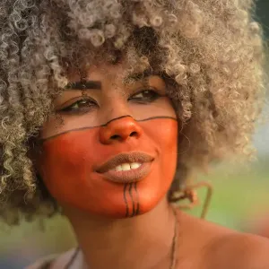Print of a smiling indigenous woman with painted face in Brasilia