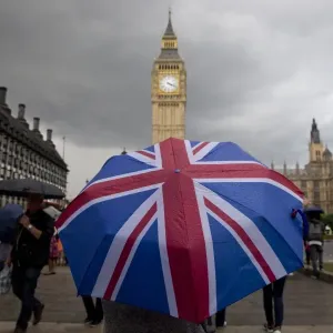 Print of a pedestrian under a Union flag umbrella near Big Ben Print of a pedestrian under a Union flag umbrella near Big Ben