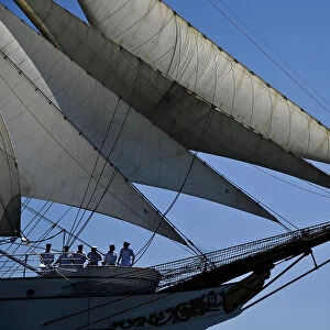 Crew members of Portuguese sailing boat Sagres sail in Tejo River in Lisbon on July 19