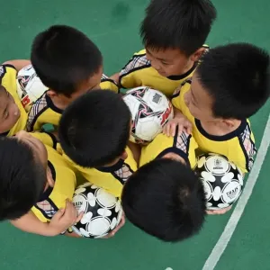 Print of children playing football in a Shanghai kindergarten Print of children playing football in a Shanghai kindergarten