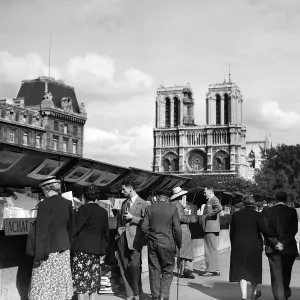 Print of Parisians browsing second-hand books near Notre Dame Print of Parisians browsing second-hand books near Notre Dame