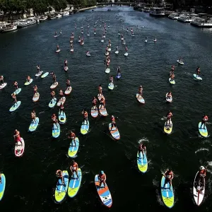 Print of stand-up paddle rally on the Seine river in Paris Print of stand-up paddle rally on the Seine river in Paris