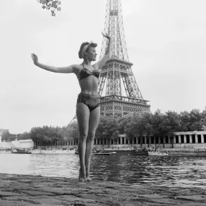Print of a woman in swimsuit posed by the Eiffel Tower