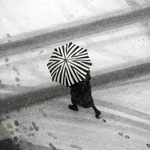 Print of a woman walking under snow in Paris, December 30, 2005 Print of a woman walking under snow in Paris, December 30, 2005