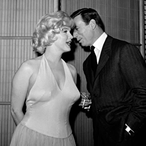 French Actor and Singer Yves Montand Whispers to Marilyn Monroe