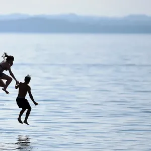 Print of Young People Jumping into Chiemsee Lake Print of Young People Jumping into Chiemsee Lake