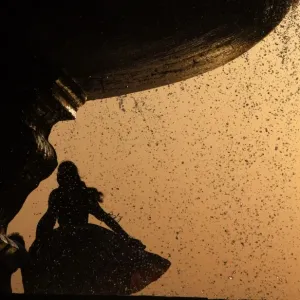 India-Weather-Fountain-Girl Print: A girl stands under a fountain near India Gate in New Delhi India-Weather-Fountain-Girl Print: A girl stands under a fountain near India Gate in New Delhi