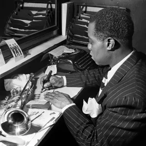 Louis Armstrong, writing a partition in his dressing room Louis Armstrong, writing a partition in his dressing room