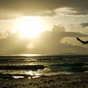 A man gestures on a beach in Dar es Salaam on April 26, 2014, as Tanzania celebrates