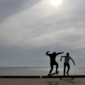 People ride a skateboard along the beach on October 7, 2016 in Saint-Nazaire, western France People ride a skateboard along the beach on October 7, 2016 in Saint-Nazaire, western France