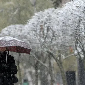 Russia Snowfall Print: Woman under Umbrella in Stavropol Russia Snowfall Print: Woman under Umbrella in Stavropol