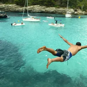 Print of a man jumping into the water at Cala n Turqueta, Menorca Print of a man jumping into the water at Cala n Turqueta, Menorca