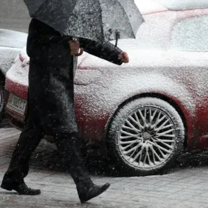 Print of a man walking on Khreshatik street in Kiev during snowfall Print of a man walking on Khreshatik street in Kiev during snowfall