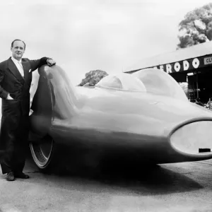Print of Donald Campbell posing near the Bluebird CN7 in England, July 1960 Print of Donald Campbell posing near the Bluebird CN7 in England, July 1960