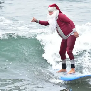 Print of Surfing Santa in action at Seal Beach, California Print of Surfing Santa in action at Seal Beach, California