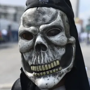 Venezuela Print: A Man in a Skeleton Mask Walking Down the Street Venezuela Print: A Man in a Skeleton Mask Walking Down the Street