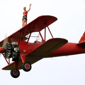 A wing-walker prerforms on a Boeing Stearman Pt13 during the WAG 2009 (World Air A wing-walker prerforms on a Boeing Stearman Pt13 during the WAG 2009 (World Air