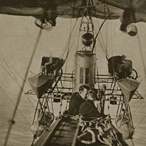 Two personnel (spotters) in the gondala suspended under a naval airship