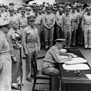 Admiral Chester Nimitz signing the Japanese surrender documents aboard USS Missouri