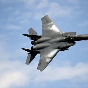 An F-15E Strike Eagle soars through the sky