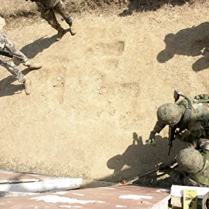 U. S. Marines throws a practice grenade into a room to clear it before they enter