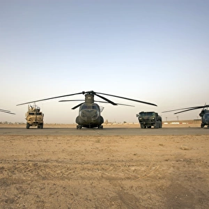 U. S. military vehicles and aircraft lined up on the taxiway at Camp Speicher, Iraq
