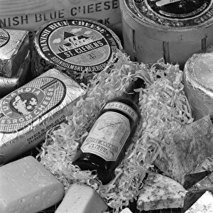 A selection of Danish cheeses and a bottle of Aalborg aquavit, 1963