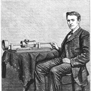 Thomas Alva Edison, American inventor, with an early hand-driven model of his phonograph, 1878