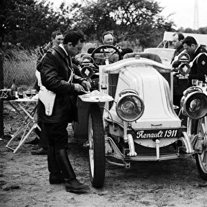 1967 24 Hours of Le Mans: CIRCUIT DE LA SARTHE, FRANCE - JUNE 11: French motorcycle policemen eat their lunch around a vintage 1911 Renault during