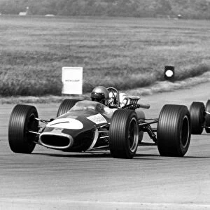 1967 British Grand Prix: Jack Brabham, Brabham BT24-Repco, 4th position, leads Chris Amon, Ferrari 312, 3rd position, action