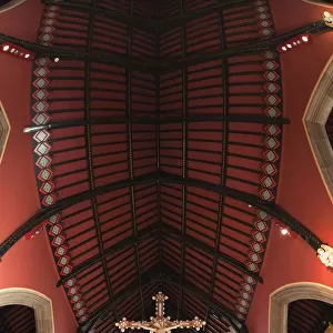 A Golden Crucifix Hanging Inside A Church; Northumberland, England