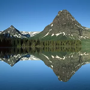 Sinopah Mountain reflects in Two Medicine Lake, southeastern part of Glacier National Park