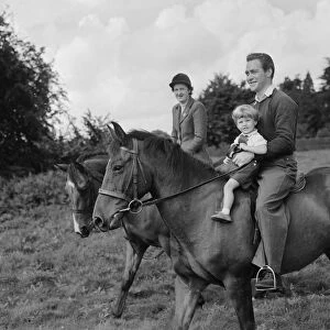 Actor Richard Todd playing with his son Peter on horseback at home