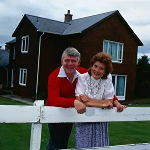 Andy Stewart singer January 1986 leaning over a fence at their home