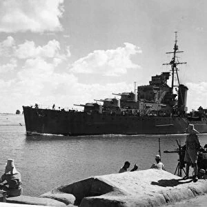 The British Light Cruiser HMS Euryalus passing an Egyptian mine spotting post on the Suez