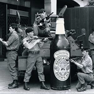 British troops guarding a 6 foot tall bottle of Newcastle brown ale standing in front of