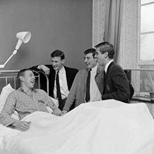 Chelsea and England right full back Ken Shellito is visited by Chelsea teammates Peter