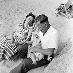 Family on the beach during a hot summer day June 1960 M4315-007